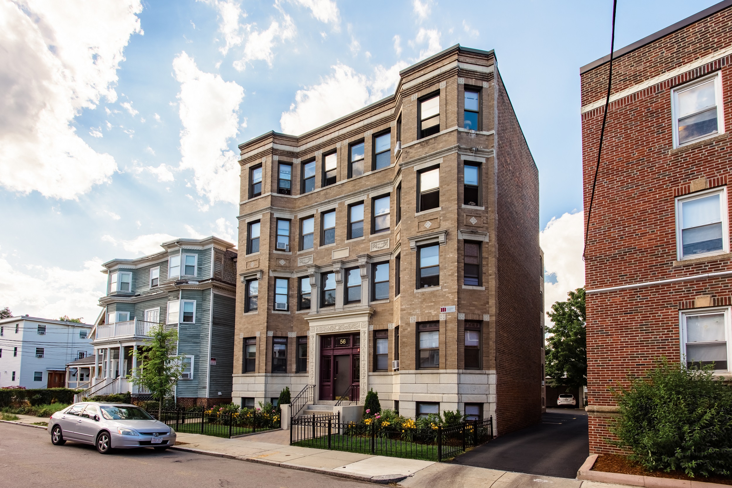 a brick building with a car parked in front of it